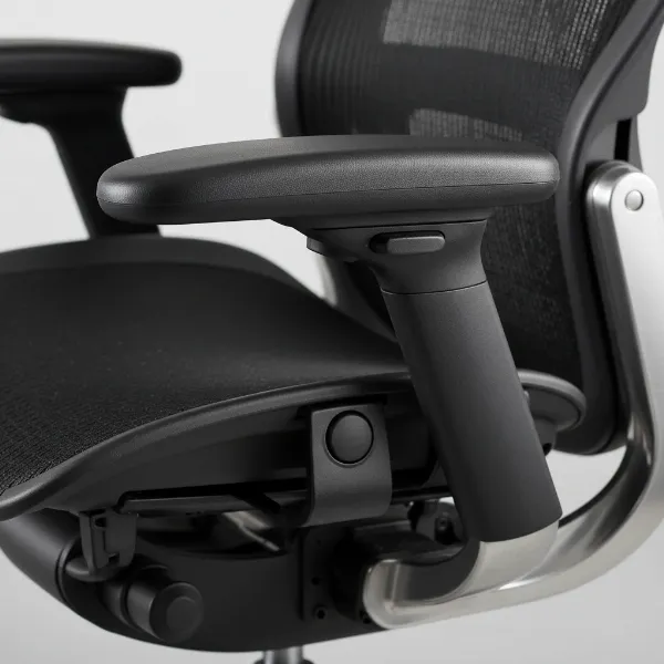 Close-up of Steelcase Leap V2 4D armrest, showing multiple adjustment points for support.